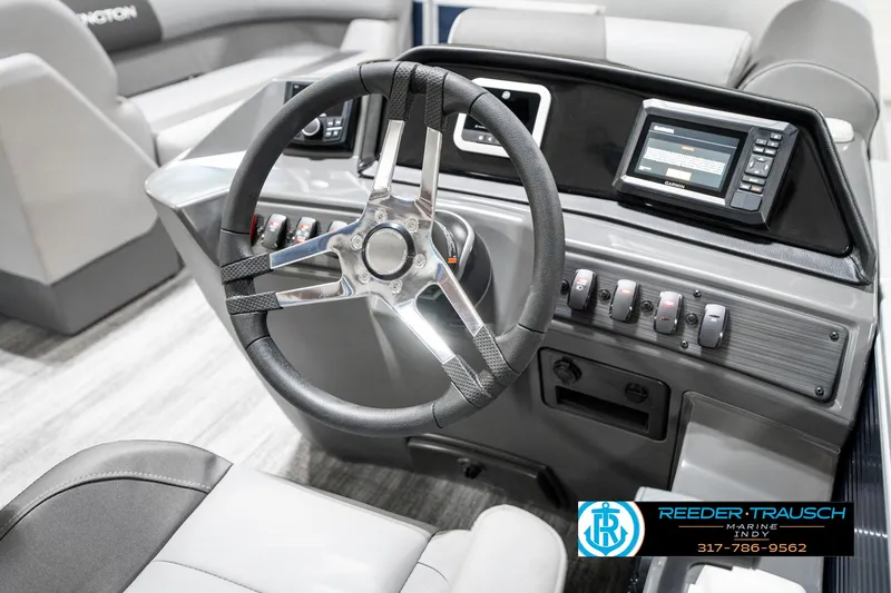 Slide: The Image of 2025 Bennington 18 SLJ boat dashboard with steering wheel and control panel. - 32