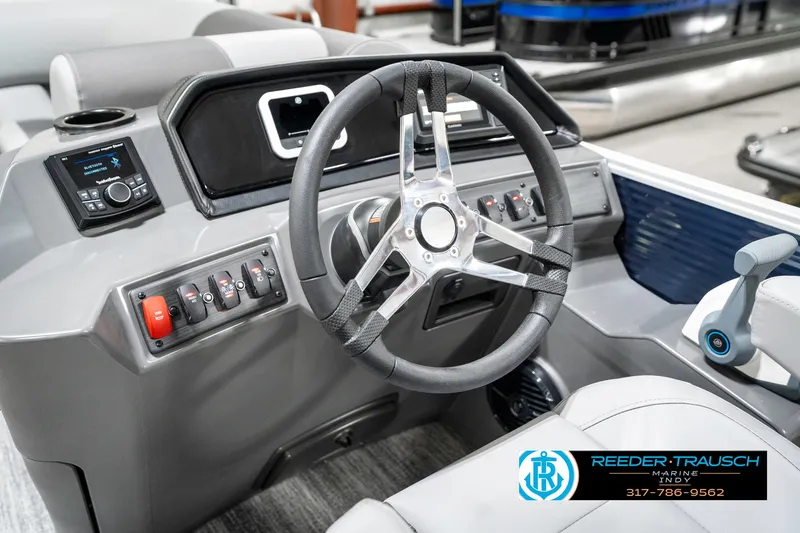 Slide: The Image of 2025 Bennington 18 SLJ boat dashboard with steering wheel and control panel. - 33