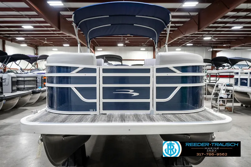 Slide: The Image of 2025 Bennington 18 SLJ pontoon boat in showroom, front view, blue and white design. - 5