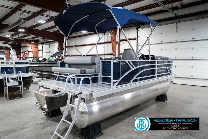 Slide: The Image of Bennington 18 SLJ 2025 pontoon boat with blue canopy in indoor showroom. - 8