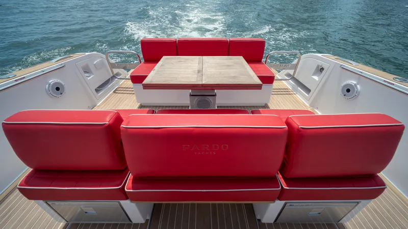Slide: The Image of 2023 Pardo Yachts 38 with red seating and wooden deck, cruising on water. - 17
