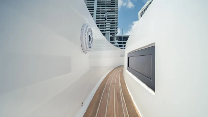Slide: The Image of 2023 Pardo Yachts 38, sleek deck design with modern architecture in the background. - 22