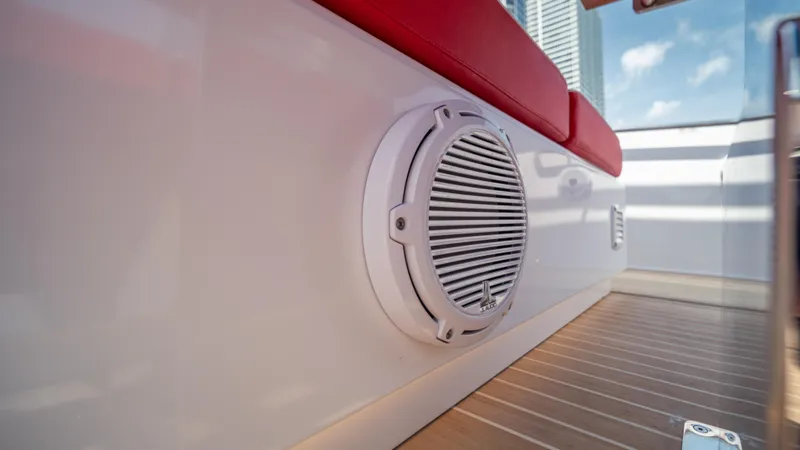 Slide: The Image of Speaker on 2023 Pardo Yachts 38, featuring red seating and wooden deck. - 30