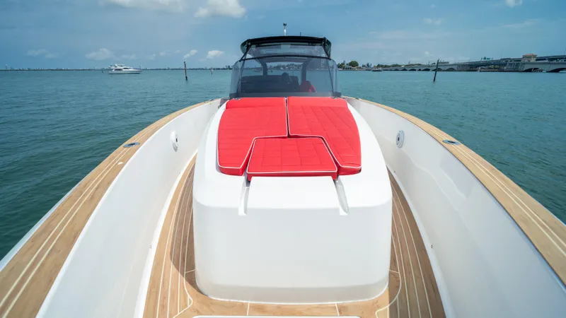 Slide: The Image of 2023 Pardo Yachts 38 with red sunbed, teak deck, cruising on calm waters. - 40