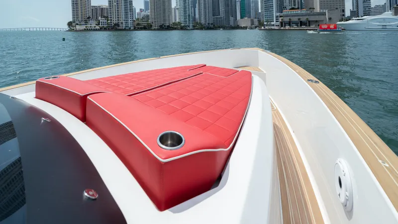 Slide: The Image of 2023 Pardo Yachts 38 with red seating, docked near city skyline. - 42