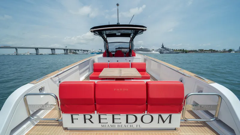 Slide: The Image of 2023 Pardo Yachts 38 with red seating, "Freedom" label, docked in Miami Beach. - 9