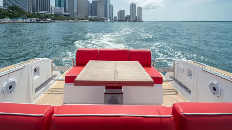 Slide: The Image of 2023 Pardo Yachts 38 with red seating, cruising near city skyline. - 15