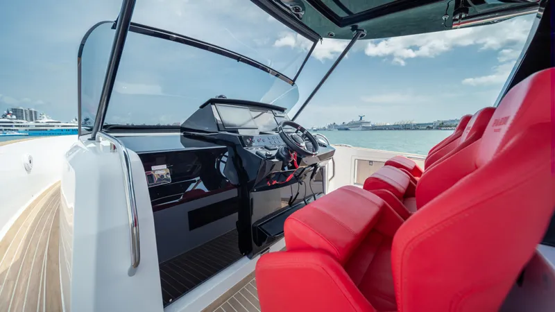Slide: The Image of 2023 Pardo Yachts 38 with red seats and sleek dashboard on open water. - 18