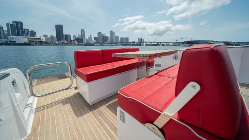 Slide: The Image of 2023 Pardo Yachts 38 with red seating, city skyline in background. - 19