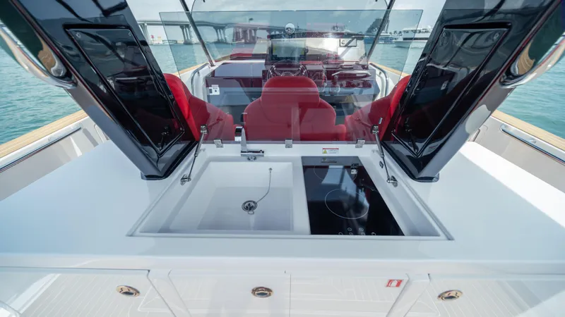 Slide: The Image of 2023 Pardo Yachts 38 interior with sink and stove, featuring red seating and modern design. - 23