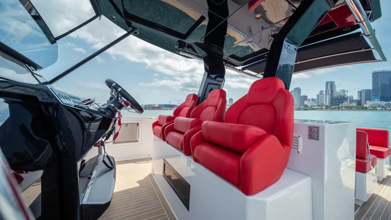 Slide: The Image of 2023 Pardo Yachts 38 interior with red seats and city skyline view. - 26