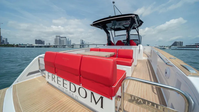 Slide: The Image of 2023 Pardo Yachts 38 with red seating, cruising on a sunny day. - 44