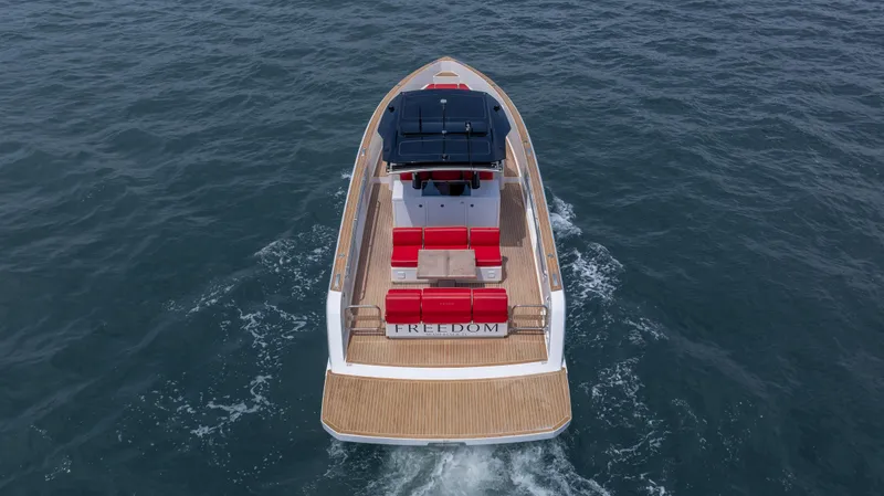 Slide: The Image of 2023 Pardo Yachts 38 cruising on open water, featuring sleek design and red seating. - 5