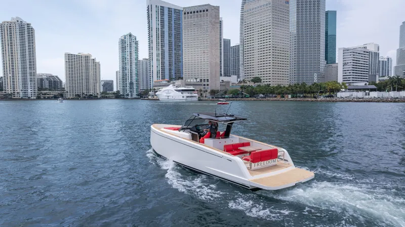 Slide: The Image of 2023 Pardo Yachts 38 cruising near city skyline, featuring sleek design and red seating. - 7