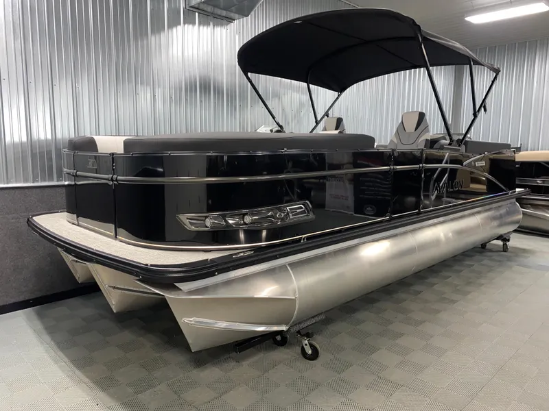 Slide: The Image of 2025 Avalon Catalina 2385 QL Tritoon boat with sleek design in showroom. - 13