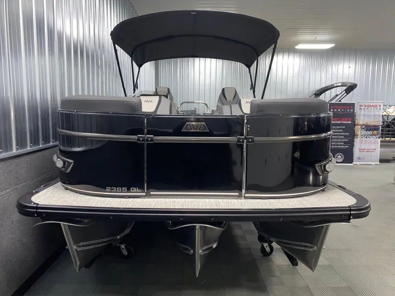Slide: The Image of 2025 Avalon Catalina 2385 QL Tritoon boat in showroom, rear view with canopy. - 14