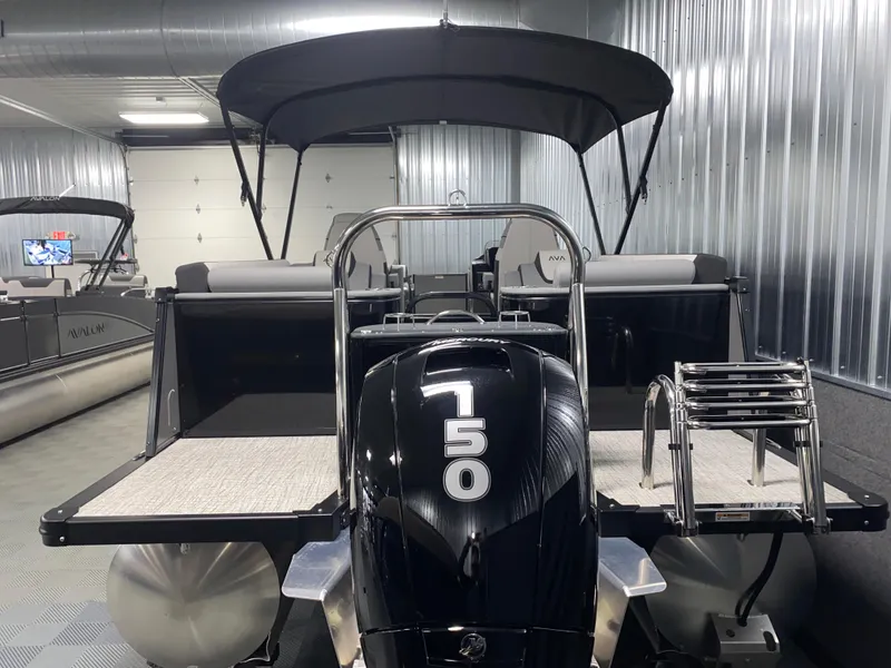 Slide: The Image of 2025 Avalon Catalina 2385 QL Tritoon with powerful 750 engine in a sleek indoor setting. - 19
