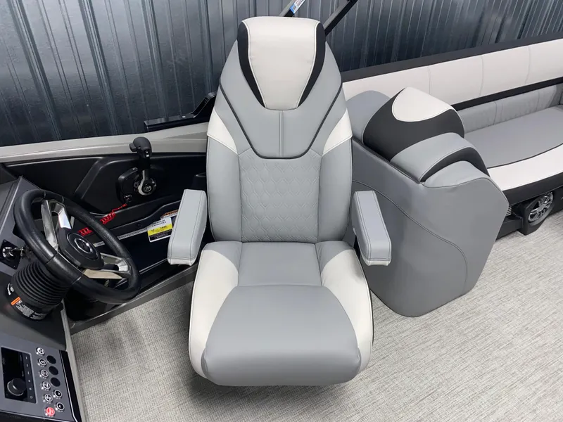 Slide: The Image of Captain's chair in 2025 Avalon Catalina 2385 QL Tritoon, featuring sleek gray upholstery. - 7