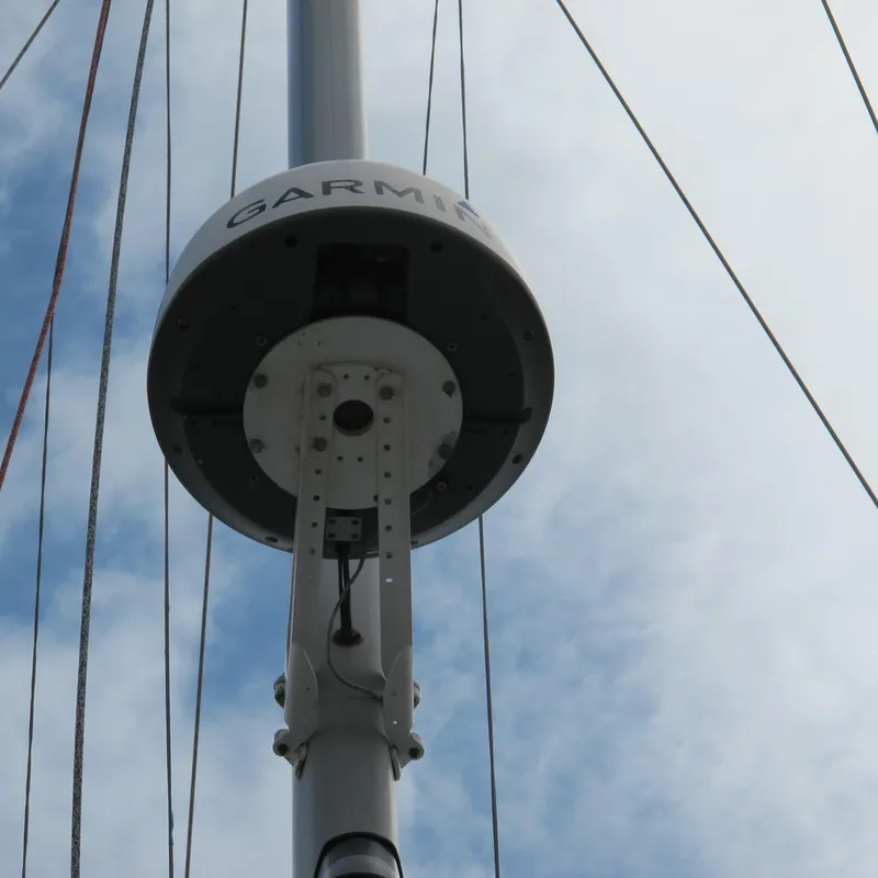 Slide: The Image of Garmin radar on Catalina 42 MkII sailboat mast, 1999 model, against cloudy sky. - 12