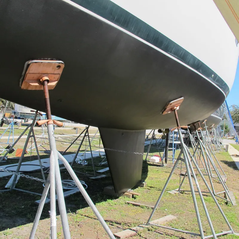 Slide: The Image of 1999 Catalina 42 MkII sailboat on stands, hull view, outdoor storage. - 15