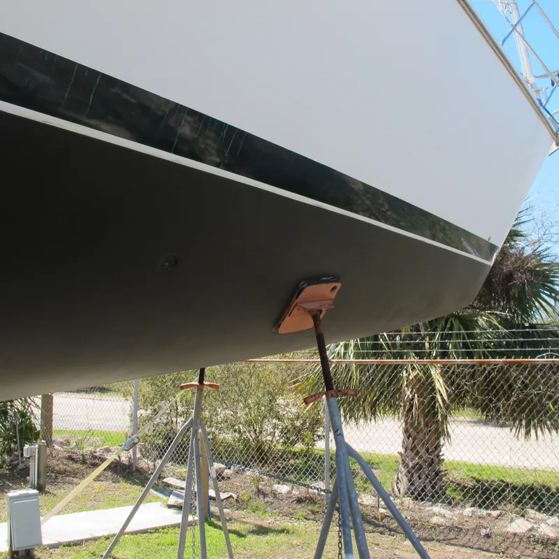 Slide: The Image of 1999 Catalina 42 MkII sailboat hull on stands, outdoor setting. - 19