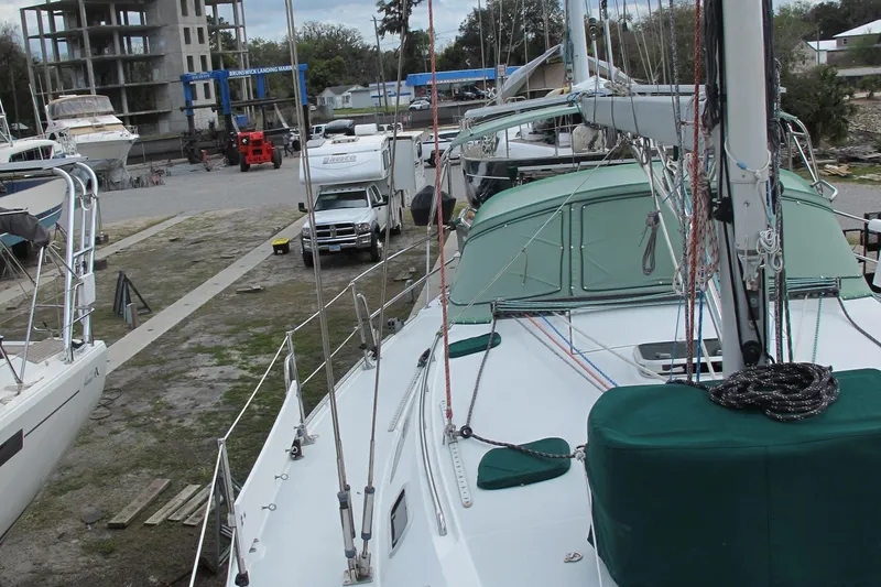 Slide: The Image of Catalina 42 MkII sailboat from 1999 docked in a marina with other boats. - 2