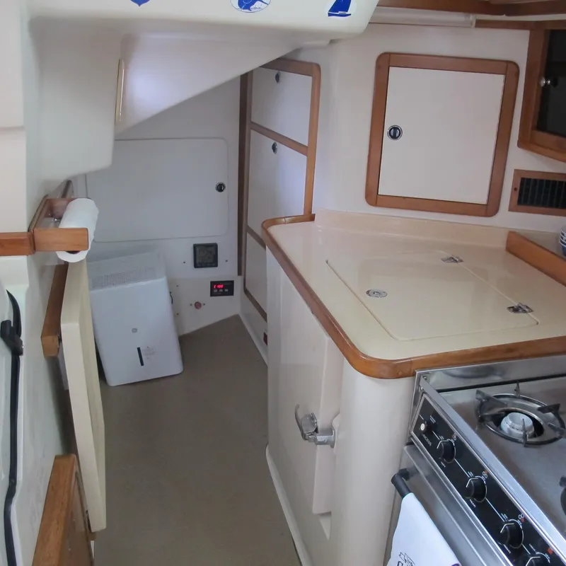 Slide: The Image of Interior of 1999 Catalina 42 MkII sailboat kitchen with stove and storage cabinets. - 32