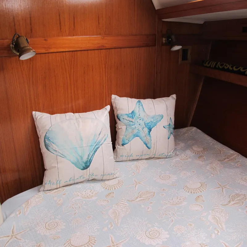 Slide: The Image of Cozy cabin interior of 1999 Catalina 42 MkII with nautical-themed pillows and bedding. - 36