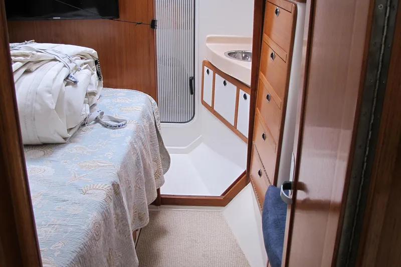 Slide: The Image of Interior of 1999 Catalina 42 MkII yacht, featuring a cozy cabin with bed and sink. - 37