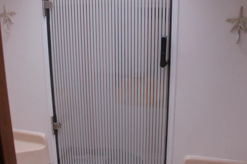 Slide: The Image of Bathroom with striped glass door on 1999 Catalina 42 MkII yacht. - 38