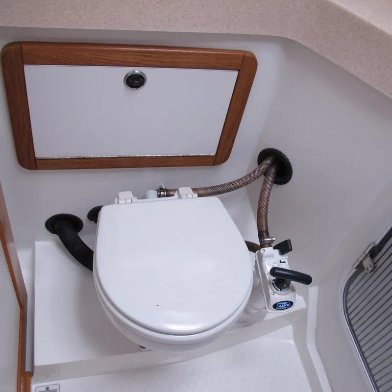 Slide: The Image of 1999 Catalina 42 MkII boat bathroom with marine toilet and storage compartment. - 39