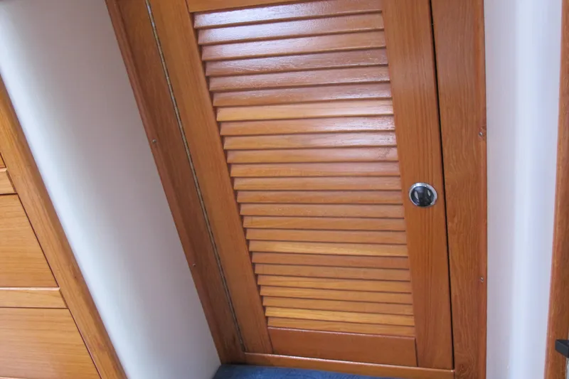 Slide: The Image of Wooden louvered door inside a 1999 Catalina 42 MkII sailboat. - 41