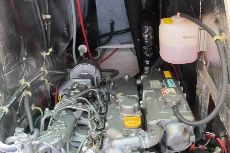 Slide: The Image of Engine compartment of a 1999 Catalina 42 MkII sailboat, showcasing mechanical components and wiring. - 46