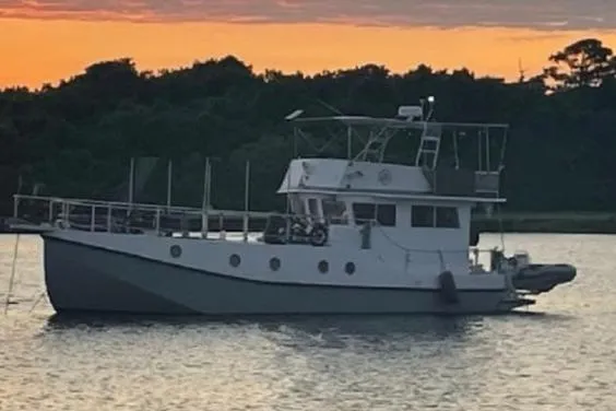 Slide: The Image of 2007 Great Harbour N47 yacht anchored at sunset on a calm waterway. - 2