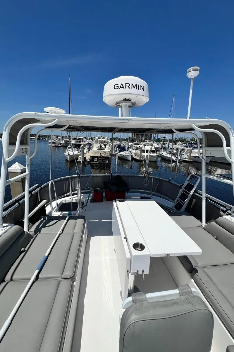 Slide: The Image of 2007 Great Harbour N47 yacht deck with seating, table, and Garmin radar, docked at marina. - 22