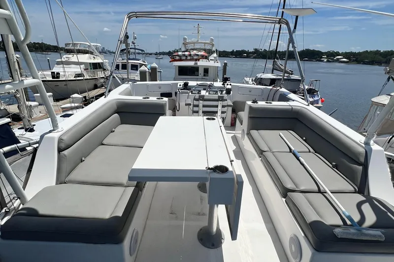 Slide: The Image of Great Harbour N47 yacht deck with seating and table, docked in a marina, 2007 model. - 23