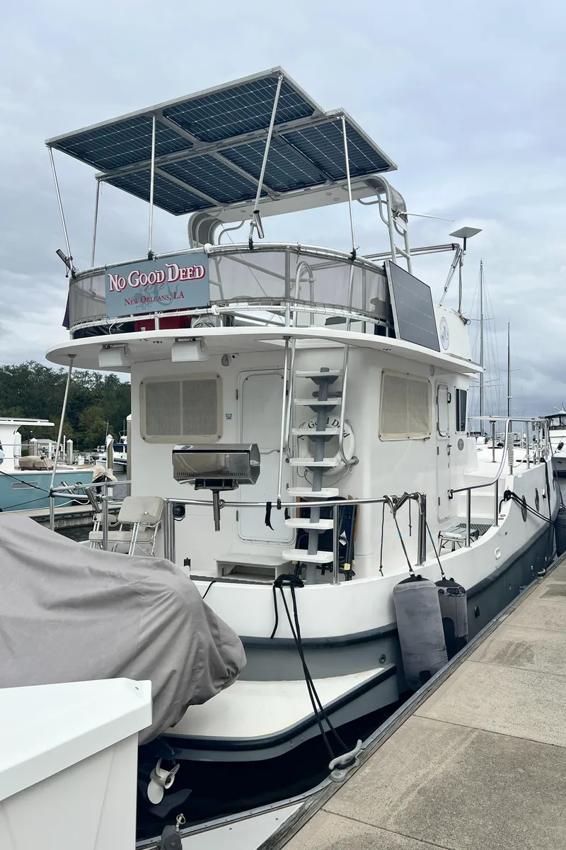 Slide: The Image of Great Harbour N47 yacht, 2007 model, docked at a marina with solar panels on top. - 3