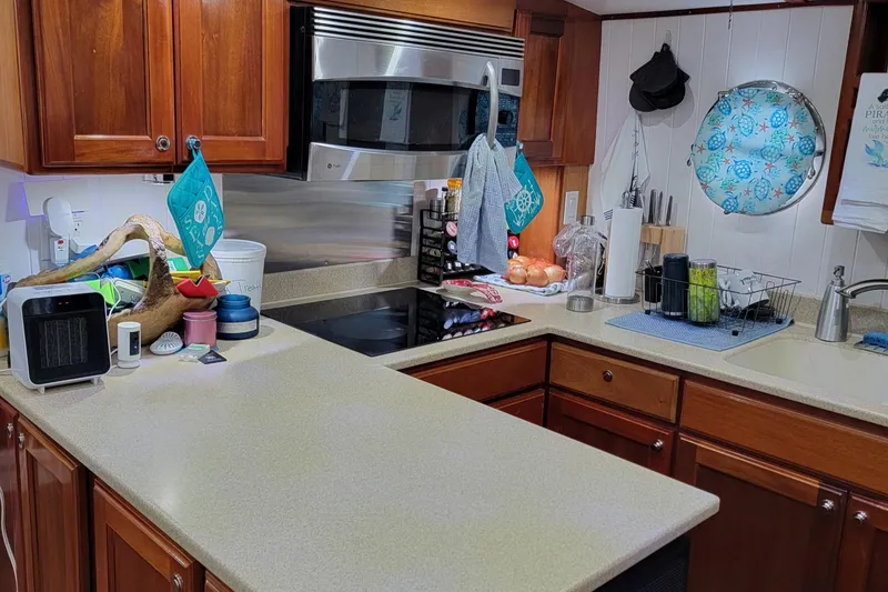 Slide: The Image of Kitchen interior of 2007 Great Harbour N47 yacht with modern appliances and wooden cabinetry. - 5