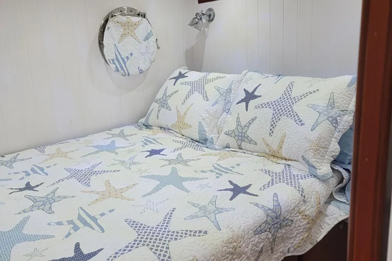 Slide: The Image of Cozy bedroom in 2007 Great Harbour N47 with starfish-themed bedding and nautical decor. - 7