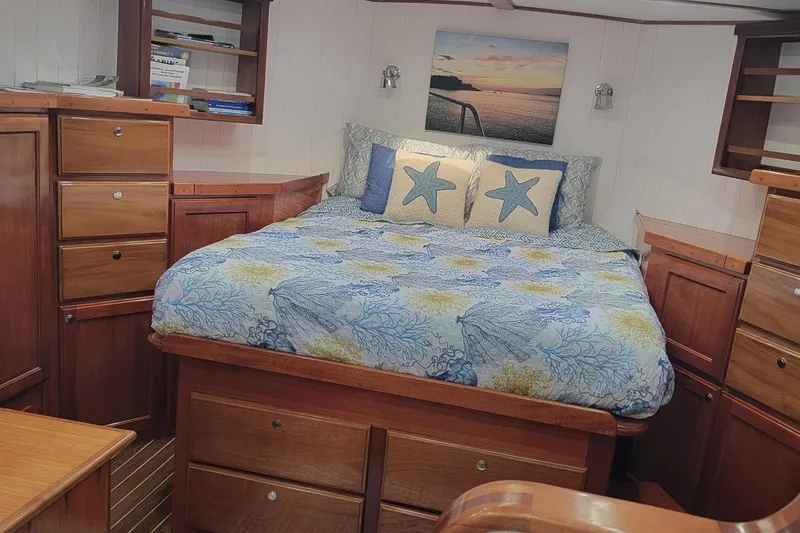 Slide: The Image of Cozy bedroom in 2007 Great Harbour N47 yacht with nautical decor and wooden cabinetry. - 8