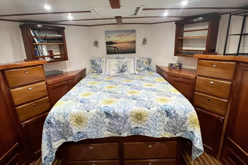 Slide: The Image of Luxurious 2007 Great Harbour N47 yacht bedroom with elegant wood cabinetry and nautical-themed bedding. - 9