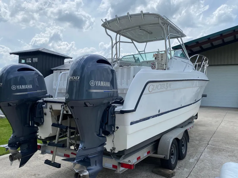 Slide: The Image of 2001 Glacier Bay 2670 Island Runner boat with twin Yamaha engines on a trailer. - 12