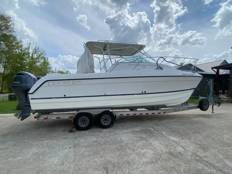 Slide: The Image of 2001 Glacier Bay 2670 Island Runner boat on trailer under cloudy sky. - 14