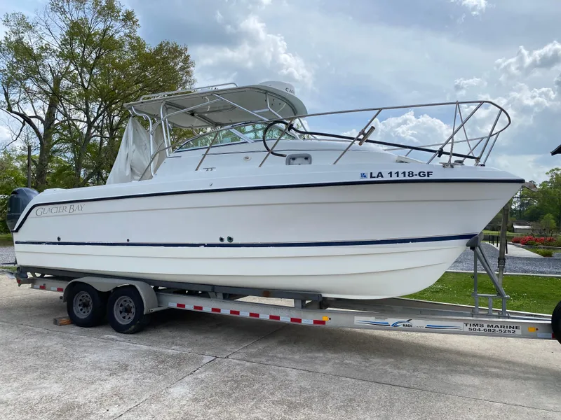 Slide: The Image of 2001 Glacier Bay 2670 Island Runner boat on trailer, parked outdoors. - 15