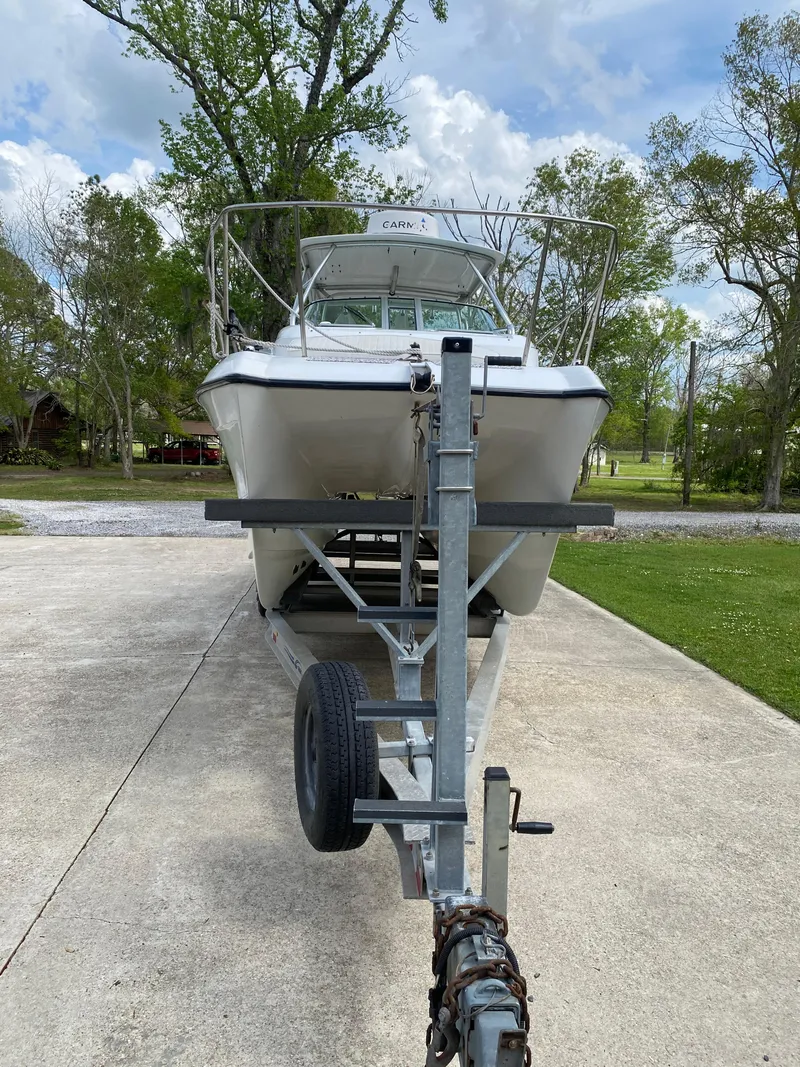 Slide: The Image of 2001 Glacier Bay 2670 Island Runner boat on trailer, parked on driveway. - 16