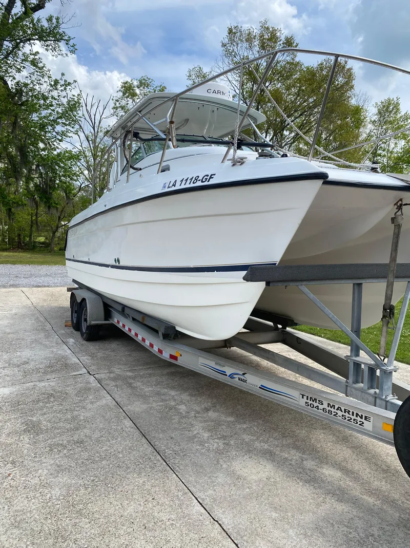 Slide: The Image of 2001 Glacier Bay 2670 Island Runner boat on trailer, parked outdoors. - 17