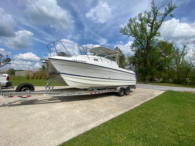 Slide: The Image of 2001 Glacier Bay 2670 Island Runner boat on trailer, parked outdoors under a cloudy sky. - 3