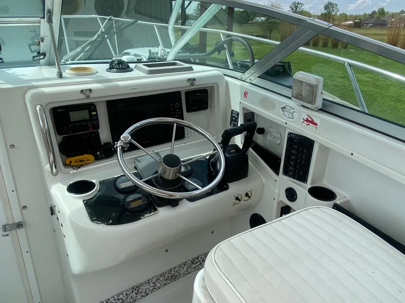 Slide: The Image of 2001 Glacier Bay 2670 Island Runner boat cockpit with steering wheel and control panel. - 5
