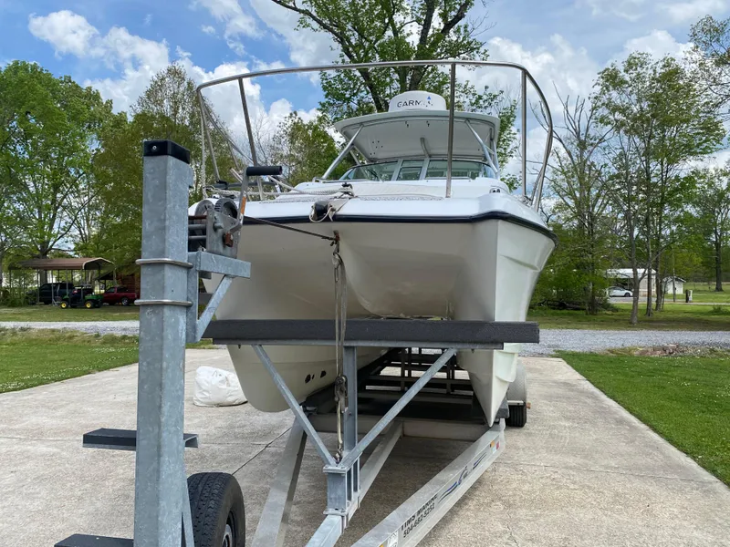 Slide: The Image of 2001 Glacier Bay 2670 Island Runner boat on trailer, parked outdoors. - 7