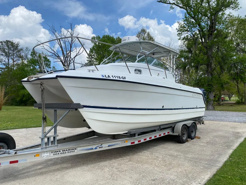 Slide: The Image of 2001 Glacier Bay 2670 Island Runner boat on trailer, parked outdoors. - 8